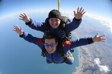 A group of experienced skydivers forming a complex formation in the sky, showcasing advanced skills.